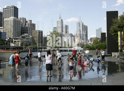 Children cooling down in the fountain on Southbank promenade in Melbourne,Australia. Stock Photo