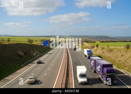 Horizontal wide angle aerial view of traffic speeding along the M4 motorway on a bright sunny day. Stock Photo