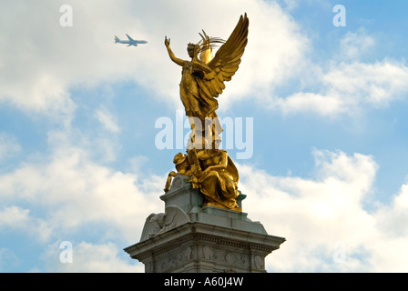 Horizontal close up of the gold statue of Victory, the pinnacle of the Queen Victoria Memorial on the Mall on a sunny day. Stock Photo