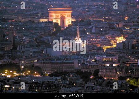 Dusk in Paris France with the Arc de Triomphe ablaze with light Stock Photo