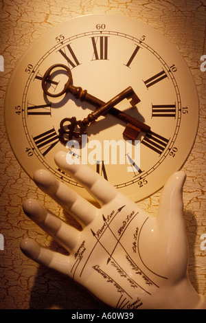Two old skeleton keys on old clock face with fortune telling hand Stock Photo