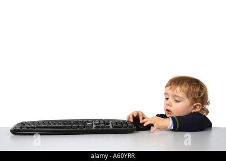 small boy with computer keyboard Stock Photo