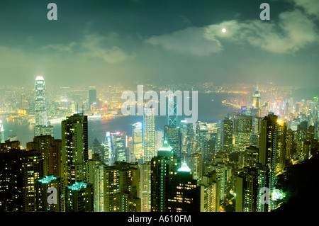 Hong Kong Island. Evening night view from Victoria Peak over city centre skyscrapers and Hong Kong Harbour to Kowloon shore Stock Photo