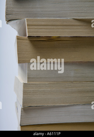 tall stack of paperback books side view Stock Photo