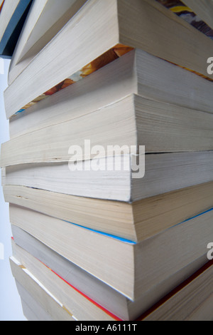 tall stack of paperback books side view Stock Photo
