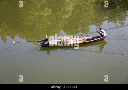 Traditional Thai Fisherman underway in Long-tailed Fishing Boat, Phuket, Thailand Stock Photo