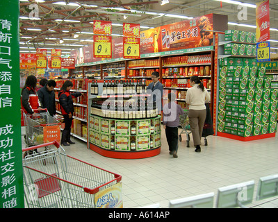 Taiwanese KT Mart store in city of Jinan, Shandong Province, China. Customers at alcoholic drinks section Stock Photo