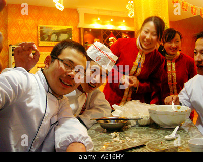 Young Chinese restaurant kitchen staff waiter waitress cook chef in city centre cafe beside Yantai Hill Park. Yantai, China. Stock Photo