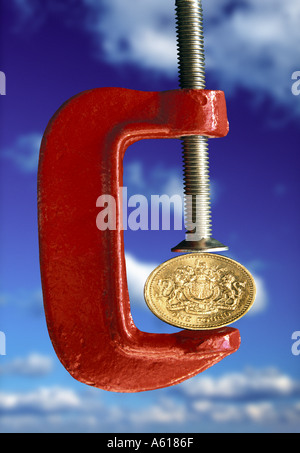 UK Pound squeezed in clamp Stock Photo