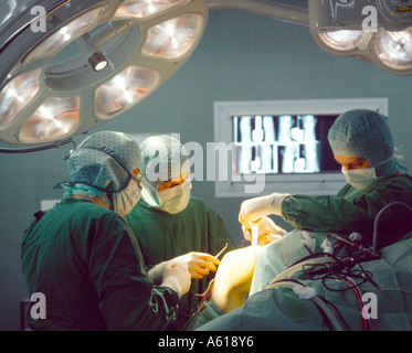 Surgeons operating on patient Stock Photo