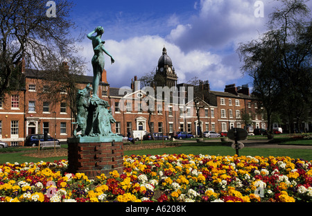 statue of circe with two fond swine in park square with leeds town hall behind built in 1858 designed by cuthbert brodrick uk Stock Photo