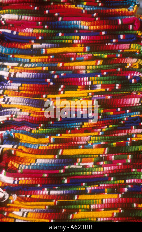 MEXICO Chiapas San Cristobal de Las Caras Close view of layered pile of multicoloured textiles Stock Photo