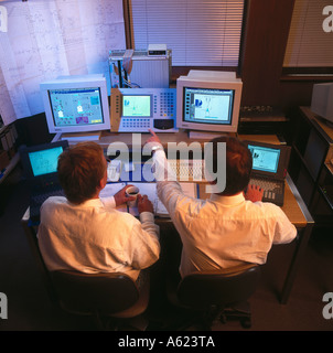 High angle view of two men working on computers in control room Stock Photo