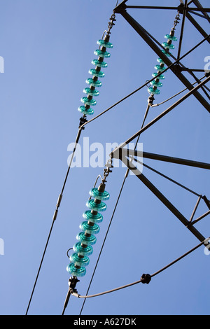 Glass insulators on electricity pylon Wales UK Stock Photo