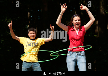 two teenagers with hula hoop tyres Stock Photo