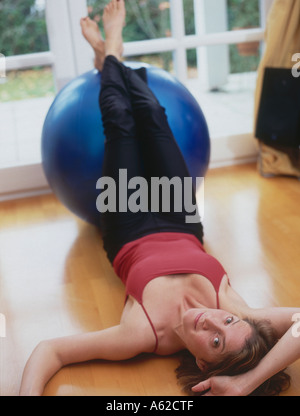 Portrait of a young woman exercising at home Stock Photo - Alamy