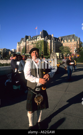 Local Scotish bag pipe player in front of the famous Empress Hotel in beautiful Victoris British Columbia Canada Stock Photo