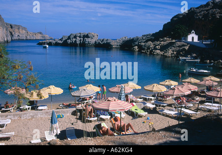 Tourists relaxing on coast, Lidos Beach, Rhodes, Greece Stock Photo