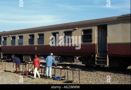 train on the of central railway line traders selling food Tanzania Stock Photo