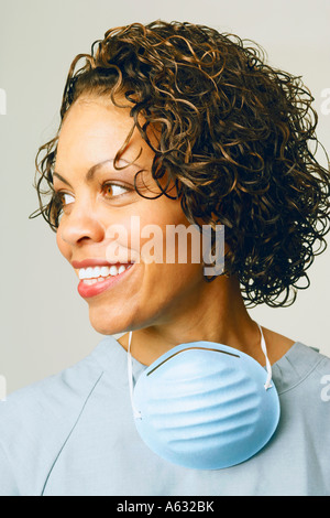 Close-up of a female nurse smiling and wearing scrubs Stock Photo