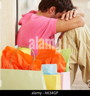 Side profile of a mid adult man leaning against a wall Stock Photo