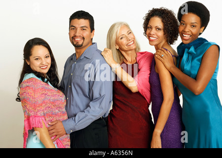 Portrait of five people standing in a row and smiling Stock Photo