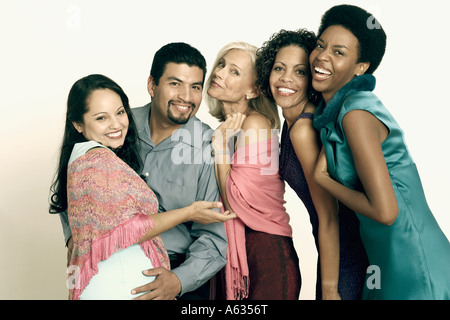 Portrait of five people standing in a row and smiling Stock Photo