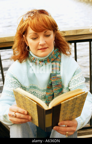 Close-up of a mature woman reading a book Stock Photo