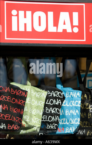 Hola sign and Barcelona souvenir bags for sale in kiosk window, La Rambla, Barcelona, Catalonia, Spain Stock Photo