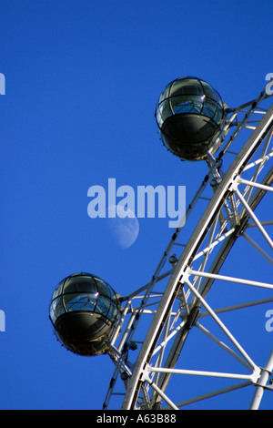 London eye capsules in closeup against a clear blue winter sky with the moon in the background Stock Photo