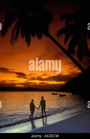 couple, romantic couple, lovers, holding hands, on beach, sunset, Qamea, Qamea Island, Fiji Island Group, Fiji Islands, Fiji Stock Photo