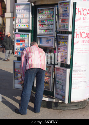 Man buying cigarettes from kiosk in Rynek Glowny, Krakow, Poland Stock Photo