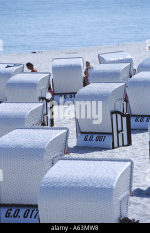 Roofed wicker beach chairs on beach, Germany Stock Photo