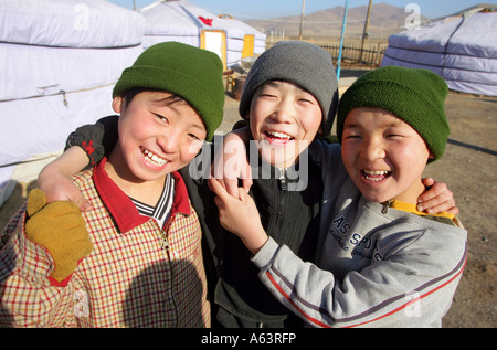 Mongolia - nomad children in front of a traditional ger in the stepps ...