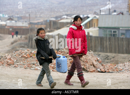 Mongolia - girls carry water jerrican from a watering place to their home Stock Photo