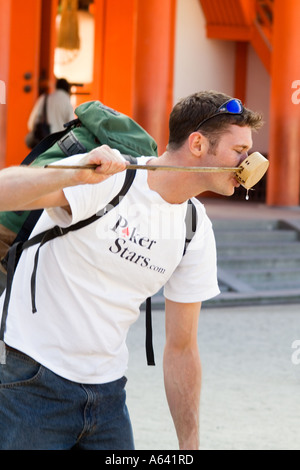 Japan, Kyoto, Man drinking from long handled cup Stock Photo