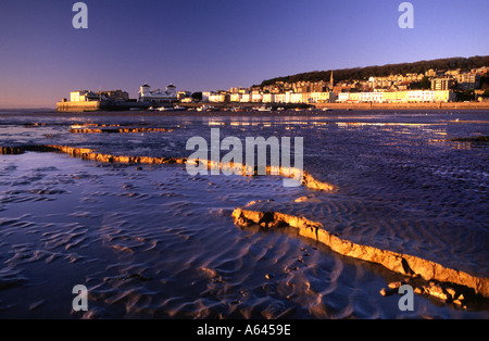 Evening light reflected off ridges in sand and mud on beach at low tide Weston super Mare England Stock Photo
