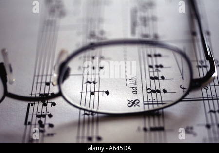 Spectacles resting on a piece of manuscript Stock Photo