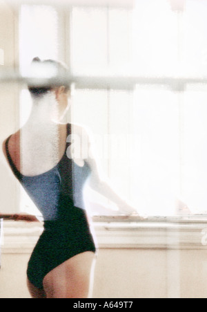 Ballerina at window in dance studio Stock Photo