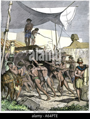 Israelite slaves building pyramids in ancient Egypt. Hand-colored woodcut Stock Photo