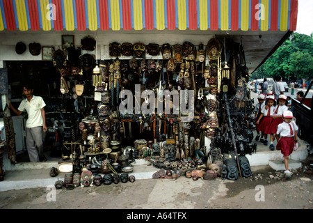 Indonesia Java Jakarta Jalan Surabaya flea market group of young schoolchildren walking past craft stall Stock Photo