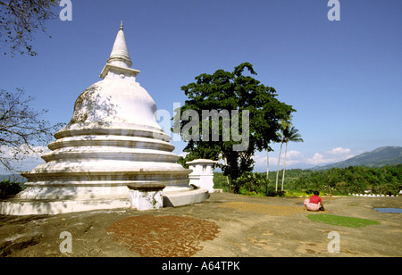 Sri Lanka Lankatilake near Kandy woman drying coffee beans by Buddhist stupa Stock Photo