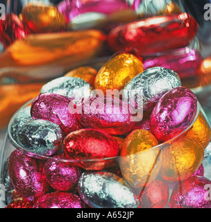 Mini chocolate eggs in a glass bowl. Stock Photo