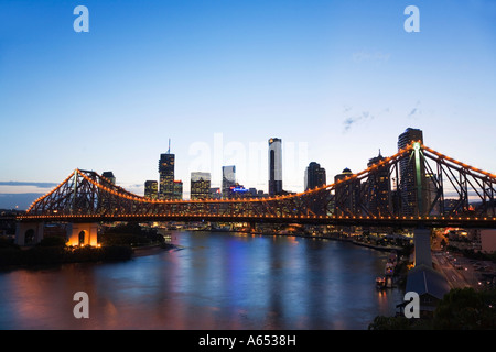 The Brisbane city skyline at dusk with the Story Bridge illuminated over the Brisbane River Stock Photo