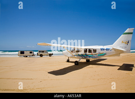 An aircraft begins to taxi along Seventy five Mile Beach on Fraser Island's eastern coast Stock Photo