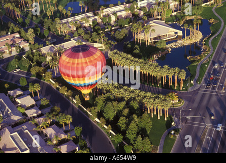 A hot air balloon flies over Palm Springs California United States of America Stock Photo