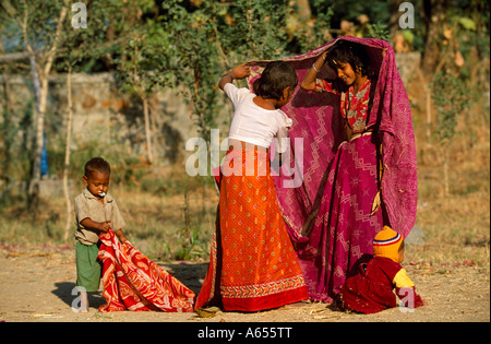 Young Rajasthani girls learning to tie saries near their rural home in Kotra a village outside Udaipur  Stock Photo