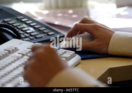 Clicking a computer mouse in the office Stock Photo