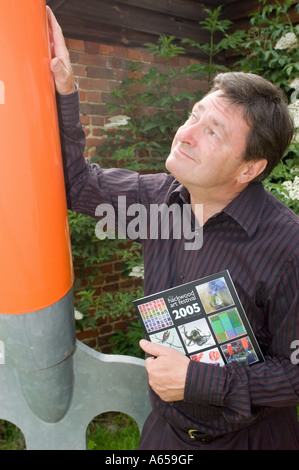 Alan Titchmarsh stands next to a giant garden fork Stock Photo