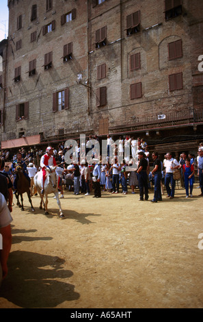 Siena Italy Tourists and Locals watching the Palio di Siena a Horse Raceheld twice a year at the Piazza Del Campo each Jockey Represents one of the Ten out of 17 Contrade Stock Photo